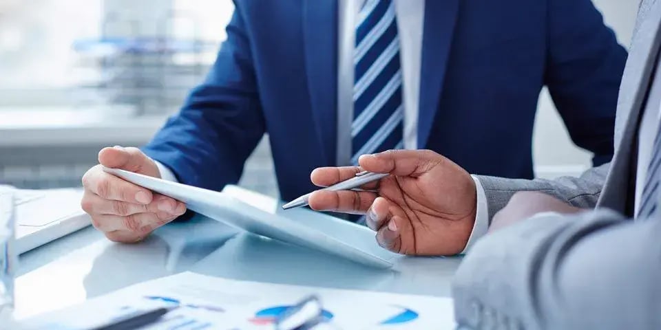 Businessperson holding an Adare Pharma Solutions resource presentation